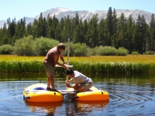 Two researchers coring a lake