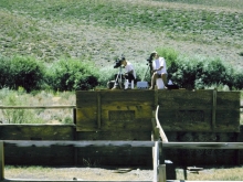 Two men video taping the field